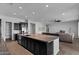 Open concept kitchen featuring an oversized granite island and views into the living room at 19372 E Timberline Rd, Queen Creek, AZ 85142