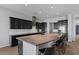 Spacious kitchen with a large island, dark cabinets, and barstool seating perfect for casual dining at 19372 E Timberline Rd, Queen Creek, AZ 85142