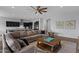 Open-concept living room featuring dark cabinetry, a comfortable sectional sofa, and tile flooring at 19372 E Timberline Rd, Queen Creek, AZ 85142