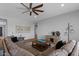 Cozy living room with tile flooring, a comfortable sofa, and stylish décor adding a touch of elegance at 19372 E Timberline Rd, Queen Creek, AZ 85142