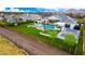 Expansive backyard with pool, sports court, and meticulous landscaping, captured in a stunning aerial view at 20690 E Sunset Dr, Queen Creek, AZ 85142