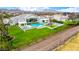 An aerial perspective highlights the luxurious backyard with its sparkling pool, sports court, and pristine landscaping at 20690 E Sunset Dr, Queen Creek, AZ 85142