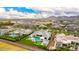 Wonderful aerial showcasing the pool, green lawns, in a scenic neighborhood and easy access to local stores at 20690 E Sunset Dr, Queen Creek, AZ 85142