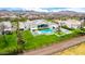 An aerial view showing a luxurious backyard with pool, sport court, and lush green landscaping at 20690 E Sunset Dr, Queen Creek, AZ 85142