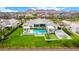 This aerial shot features a stunning backyard with a pool, sports court, and impeccable landscaping at 20690 E Sunset Dr, Queen Creek, AZ 85142