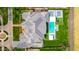 An aerial view of a luxury home featuring a swimming pool, sports court and lush green landscaping at 20690 E Sunset Dr, Queen Creek, AZ 85142