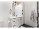 Modern bathroom featuring sleek white cabinetry, black hardware, and eye-catching black and white patterned tile flooring at 20690 E Sunset Dr, Queen Creek, AZ 85142
