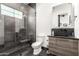 Sleek bathroom with a dark wood vanity, modern fixtures, and a glass shower with gray tiling at 20690 E Sunset Dr, Queen Creek, AZ 85142