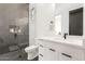 Modern bathroom featuring black and white geometric tiles, a sink vanity and a glass enclosed shower at 20690 E Sunset Dr, Queen Creek, AZ 85142