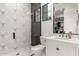 Modern bathroom featuring patterned tile shower and white vanity with closet view at 20690 E Sunset Dr, Queen Creek, AZ 85142