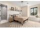 Cozy bedroom with neutral decor, paneled accent wall and an ensuite bath at 20690 E Sunset Dr, Queen Creek, AZ 85142