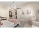Bedroom with hanging chair, sliding barn door to bathroom, and chandelier at 20690 E Sunset Dr, Queen Creek, AZ 85142