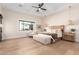 Spacious primary bedroom featuring a tray ceiling, a large bed, and access to an outdoor space at 20690 E Sunset Dr, Queen Creek, AZ 85142