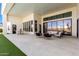 Expansive covered patio with a lounge area, dining, and large glass doors at 20690 E Sunset Dr, Queen Creek, AZ 85142