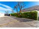 Exterior view showcasing driveway, tall shrubbery, and providing a sense of privacy and seclusion at 20690 E Sunset Dr, Queen Creek, AZ 85142