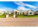 Stunning exterior showcasing brick entry, lush landscaping, and well-maintained lawn, creating an inviting entrance at 20690 E Sunset Dr, Queen Creek, AZ 85142