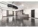 Expansive garage with epoxy floors, storage cabinets, sink and plenty of space for vehicles and storage at 20690 E Sunset Dr, Queen Creek, AZ 85142