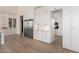 Bright kitchen with stainless steel refrigerator, custom cabinetry, and marble countertops at 20690 E Sunset Dr, Queen Creek, AZ 85142