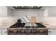 Close-up of a high-end stainless steel gas range with a modern backsplash and cabinetry at 20690 E Sunset Dr, Queen Creek, AZ 85142