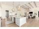 Bright, open-concept kitchen features a large island, stainless steel appliances, and decorative pendant lighting at 20690 E Sunset Dr, Queen Creek, AZ 85142