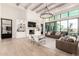 Stylish living room featuring built-in shelving, a fireplace, and seamless access to the outdoors at 20690 E Sunset Dr, Queen Creek, AZ 85142