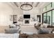 Stylish living room featuring built-in shelving, a fireplace, and seamless access to the outdoors at 20690 E Sunset Dr, Queen Creek, AZ 85142