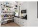 Organized walk-in pantry with open shelving, drawers, countertop, and plenty of storage space at 20690 E Sunset Dr, Queen Creek, AZ 85142