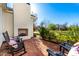 Outdoor patio with fireplace, seating, and manicured landscaping in a well-maintained backyard at 20690 E Sunset Dr, Queen Creek, AZ 85142