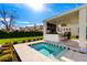 Beautiful backyard with a pool, spa, and an outdoor kitchen with bar seating at 20690 E Sunset Dr, Queen Creek, AZ 85142