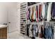 Organized walk-in closet with a full range of shoe shelves and multiple clothing rods at 20690 E Sunset Dr, Queen Creek, AZ 85142