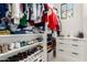 Organized walk-in closet with shelving for shoes and clothes, plus drawers and a window at 20690 E Sunset Dr, Queen Creek, AZ 85142