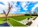 Large private backyard features a manicured lawn and landscaping creating a serene outdoor space at 20690 E Sunset Dr, Queen Creek, AZ 85142