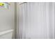 Close-up of toilet and shower curtain in the bathroom at 2571 S Melvin St, Gilbert, AZ 85295