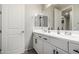 Bathroom with double sink vanity, white cabinets, and modern black hardware at 2571 S Melvin St, Gilbert, AZ 85295