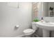 Powder bathroom with pedestal sink, modern fixtures, decorative wall hanging and neutral paint at 2571 S Melvin St, Gilbert, AZ 85295