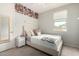 Bedroom with plush carpet, decorative accent wall, neutral paint, and ample natural light at 2571 S Melvin St, Gilbert, AZ 85295