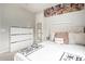 Bedroom with plush carpet, decorative accent wall, neutral paint, and ample natural light at 2571 S Melvin St, Gilbert, AZ 85295