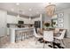 Open kitchen and dining area with white cabinets, pendant lighting, and island seating at 2571 S Melvin St, Gilbert, AZ 85295