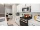 Updated kitchen boasts stainless steel appliances, white cabinets, and a streamlined design at 2571 S Melvin St, Gilbert, AZ 85295