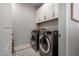 Laundry room featuring modern appliances and ample storage space at 2571 S Melvin St, Gilbert, AZ 85295