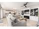 Open-concept living room with stylish decor, fireplace, and seamless connection to the kitchen at 2571 S Melvin St, Gilbert, AZ 85295