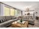Comfortable living room with sliding glass doors to outdoor space and view of kitchen and chandelier at 2571 S Melvin St, Gilbert, AZ 85295