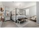 Main bedroom with four-poster bed, soft carpet, neutral colors, chandelier, and decorative accents at 2571 S Melvin St, Gilbert, AZ 85295