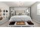 Main bedroom with four-poster bed, soft carpet, neutral colors, chandelier, and decorative accents at 2571 S Melvin St, Gilbert, AZ 85295