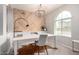 Bright home office features wooden herringbone accent wall, chandelier and large window at 2571 S Melvin St, Gilbert, AZ 85295