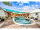 Landscaped backyard with refreshing pool, multiple lounge spots under colorful sunshades for outdoor entertainment at 3126 N 17Th Dr, Phoenix, AZ 85015