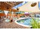 Inviting backyard with pool and patio, covered by wood pergola and sunshades, offering a perfect outdoor retreat at 3126 N 17Th Dr, Phoenix, AZ 85015