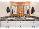 Contemporary bathroom showcasing double sinks, marble countertops, decorative mirrors, and modern lighting fixtures at 3126 N 17Th Dr, Phoenix, AZ 85015