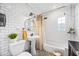 Bright bathroom featuring white subway tile, mosaic flooring, a pedestal sink, and a bathtub at 3126 N 17Th Dr, Phoenix, AZ 85015