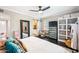 Bright bedroom with ceiling fan, and access to a bathroom with modern fixtures and a barn door entry at 3126 N 17Th Dr, Phoenix, AZ 85015
